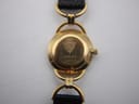 Close-up of the watch case back, revealing the Gucci crest, model number 6000.2.L, and serial number 9391527.
