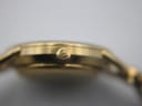 Macro shot of the watch crown, clearly showing the debossed Gucci 'GG' logo.