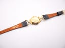 Close-up of the underside of the black leather strap, showing "13 H HIRSCH Rainbow" marking and its brown inner lining.
