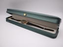 The Gucci watch displayed inside a green presentation box with a cream interior.
