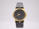 Front view of the Gucci 3400M watch with a gold-plated case, black dial, gold Roman numerals, and a black lizard-grain leather strap.