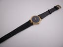 Full length view of the Gucci 3400M watch with its black leather strap extended, displayed on a white surface.