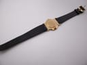 Full length back view of the Gucci 3400M watch with its black leather strap extended, showing the case back and strap reverse.