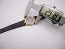 Digital caliper measuring the case diameter of the Gucci 3400M watch, displaying an exact measurement of 29.78 mm.