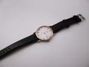 Full length top view of the Bulova watch with its black leather strap laid flat.