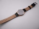 Full length back view of the Bulova watch, showing the case back and the genuine leather strap interior.