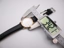 Digital caliper measuring the Bulova watch case diameter at 34.2mm.