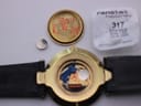 Front view of the Gucci 4500 M watch with a cream dial, gold hands, and two-tone gold and silver case on a black leather strap.