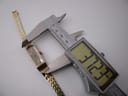 Digital caliper measuring the length of the Seiko watch case, displaying 31.23mm.