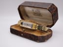 Angled view of the vintage Seiko 1520 watch sitting in an open, ornate vintage presentation box, showing the gold bracelet. (Note: this box is not included with the watch.)
