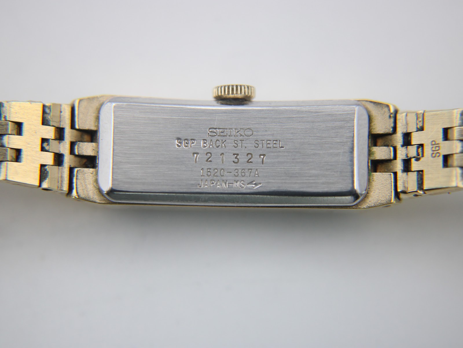 Clear view of the stainless steel case back, showing engravings: 'SEIKO SGP BACK ST. STEEL 721327 1520-367A JAPAN-MS'.