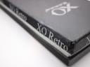 Side view of the black XO RETRO presentation box, highlighting its texture and the repeated brand name along the edge.
