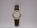 Front view of gold Raymond Weil 9940 quartz watch with white Roman numeral dial and brown leather strap.