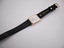 Rear view of the Seiko watch and strap, revealing the "GENUINE LEATHER 18" marking on the strap and the watch's case back.