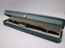 The Seiko E029-5540 watch resting neatly inside a green presentation box, showcasing its gold case and black strap.