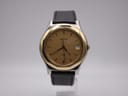 Front view of the Tissot PRX P380 watch with a gold dial and two-tone case on a black leather strap.
