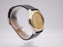 Right side view of the Tissot PRX P380 highlighting the gold-tone bezel and stainless steel case profile.