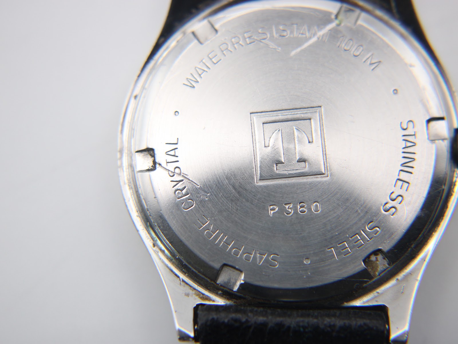 Close-up of the Tissot PRX P380 stainless steel case back showing engravings for "Waterresistant 100M", "Sapphire Crystal", Tissot logo, and model "P380".