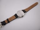 Back view of the Tissot PRX P380 showing the stainless steel case back and the reverse side of the replacement 'Condor' marked leather strap.