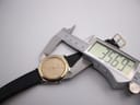 Digital caliper measuring the case diameter of the Tissot PRX P380 watch, displaying an exact measurement of 35.69mm.