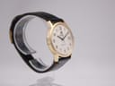 Left-side angled view of the Roamer Searock watch, highlighting the gold tone case profile and black leather strap.