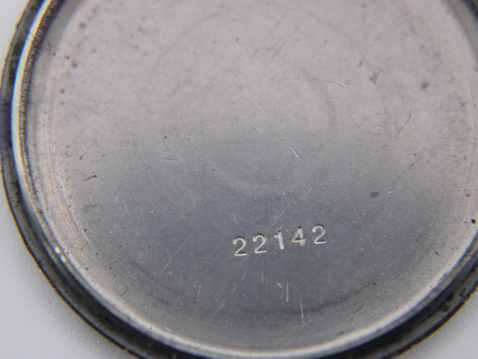 Inner view of the case back showing the serial number '22142'.