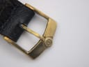 Close-up of the gold tone buckle with an embossed Roamer logo.