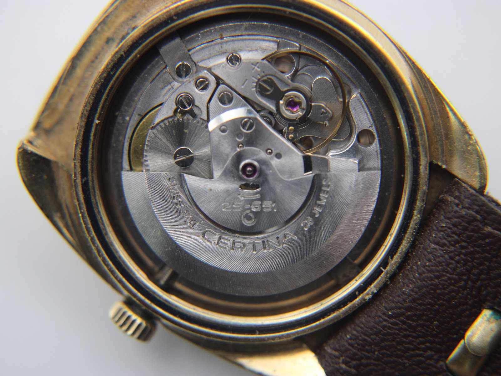 Close-up view of the Certina 25-651 automatic movement inside the watch, showing '28 JEWELS' and 'SWISS' markings.