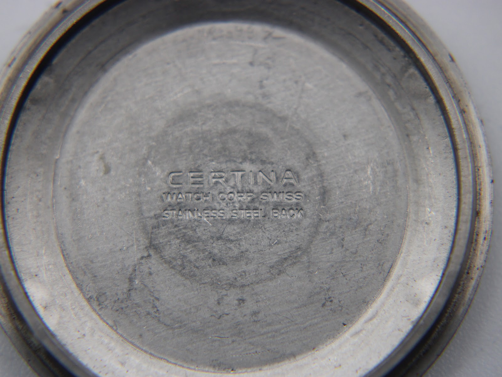 Close-up of the inner stainless steel case back, showing 'CERTINA WATCH CORP SWISS STAINLESS STEEL BACK' engraving.