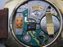 Close-up of the Eterna Quartz 1558 electronic movement inside the watch with battery and circuit board.