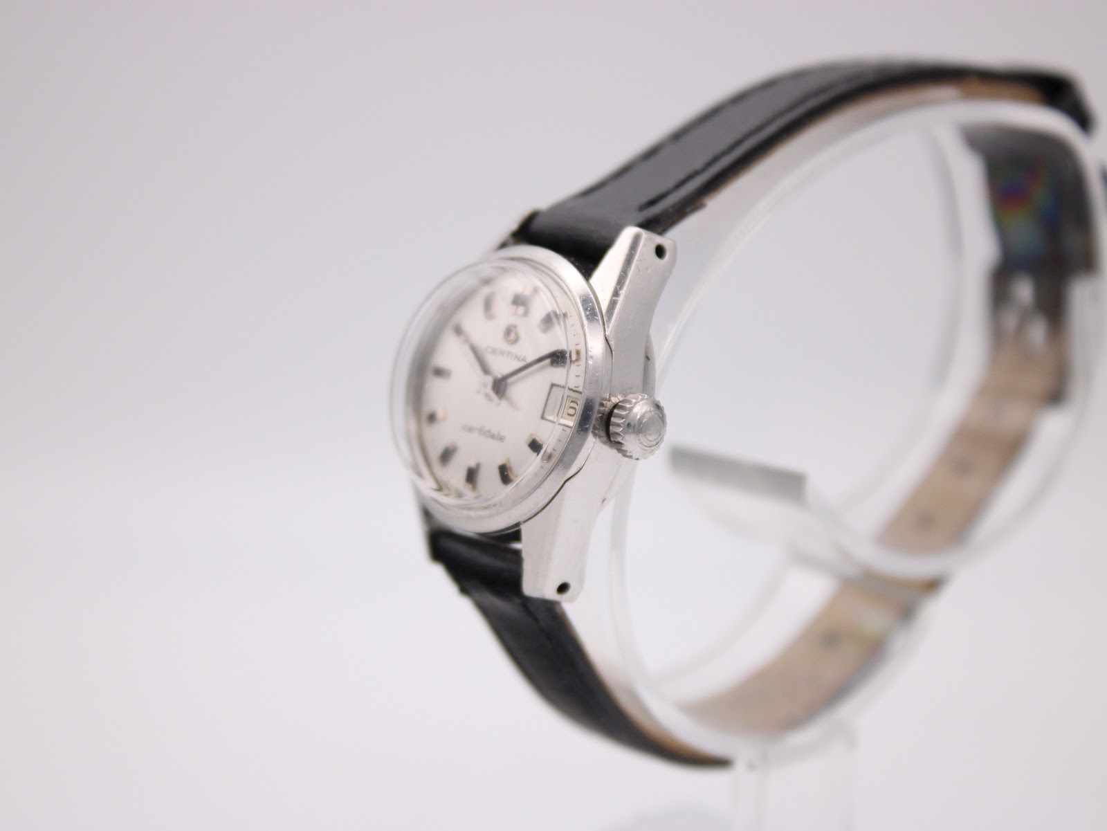 Right side profile view of the Certina Certidate watch on a display stand, showing the stainless steel case and unsigned crown.