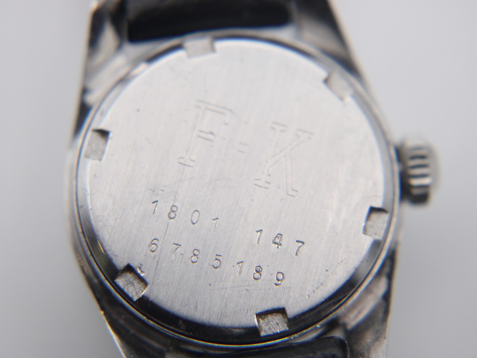 Close-up of the Certina Certidate watch case back, showing engraved serial number 6785189 and model details.