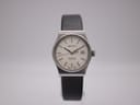 Front view of the Zenith Espada watch with cream dial and black leather strap, presented on a clear watch stand.