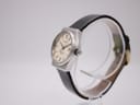Angled side view of the Zenith Espada watch, showing the crown and case profile on a clear watch stand.