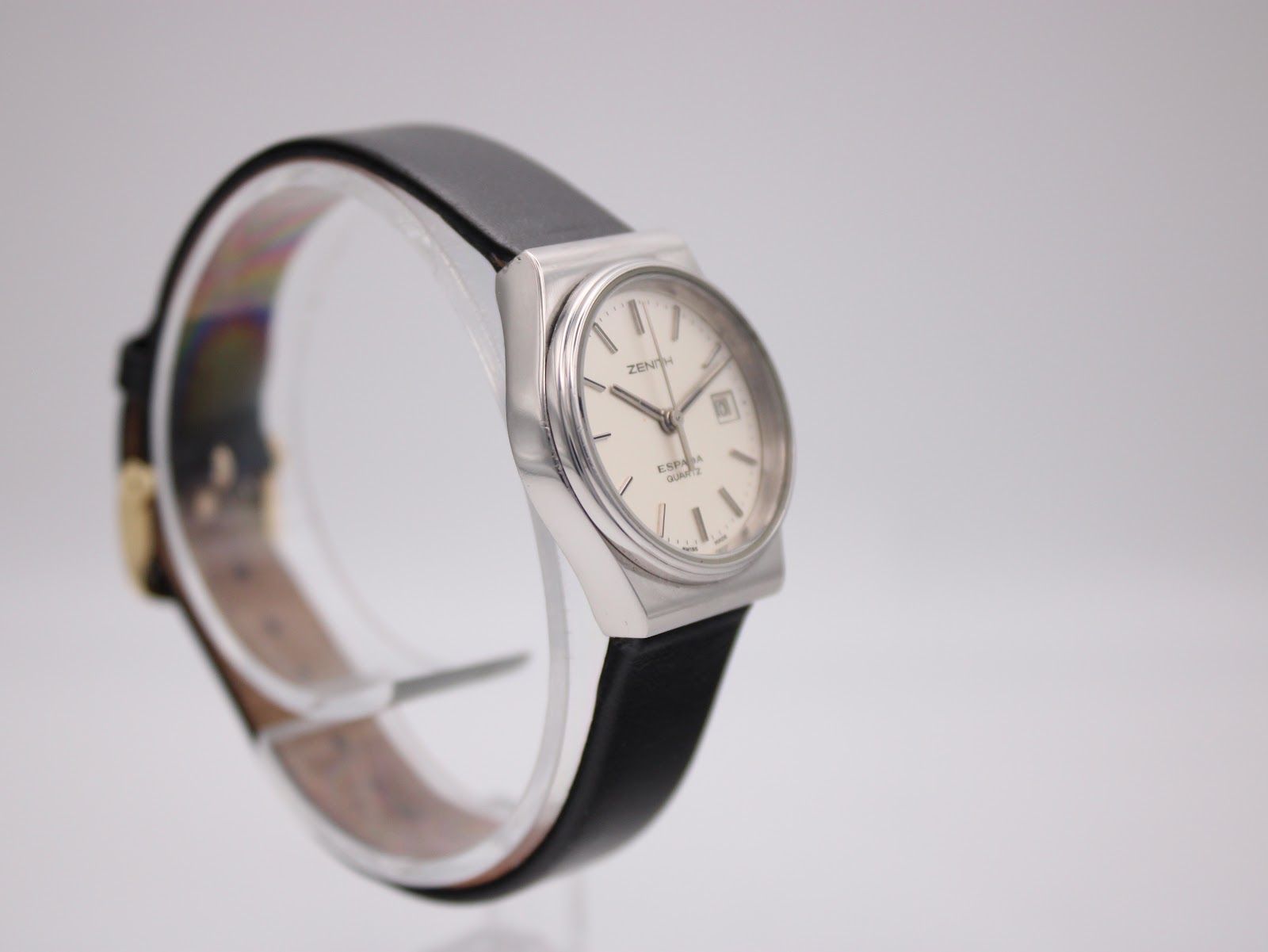 Another angled side view of the Zenith Espada watch, showing the opposite side of the case on a clear watch stand.