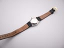 Back view of the Zenith Espada watch, showing the case back and the underside of the black leather strap with buckle.