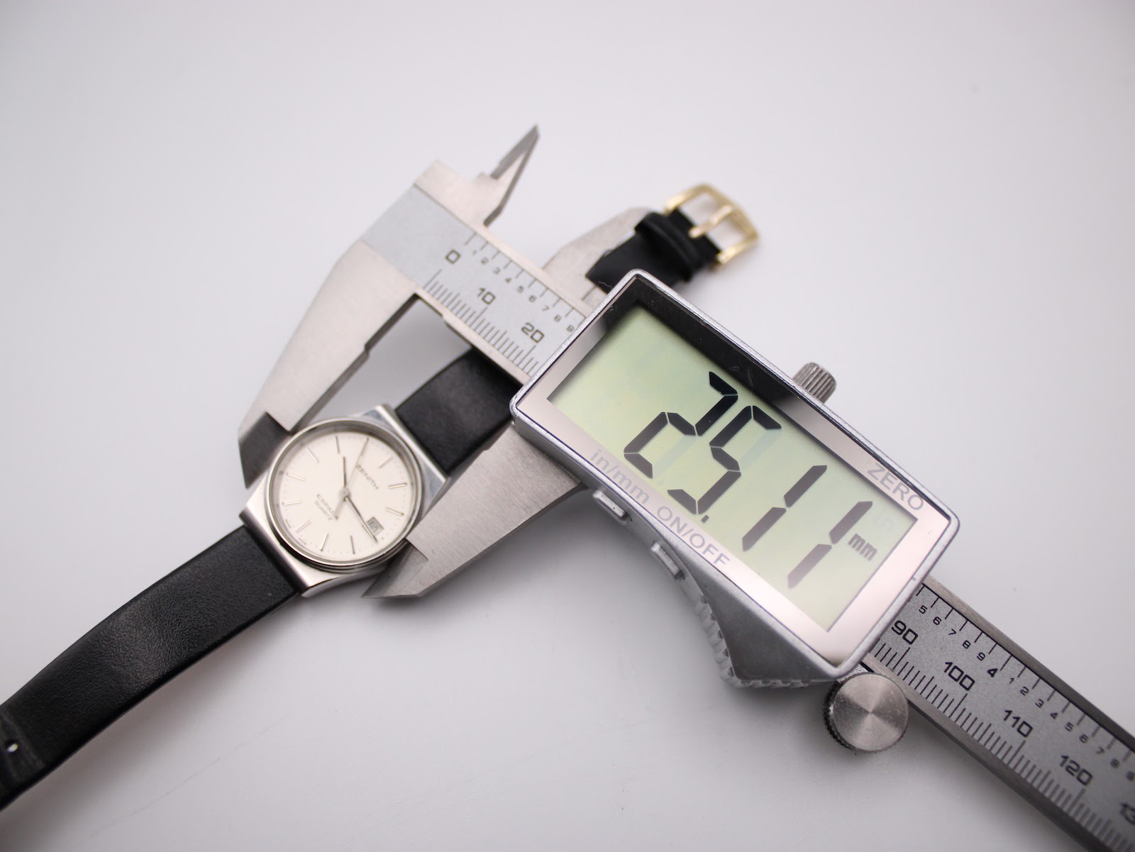 Digital caliper measuring the Zenith Espada watch case diameter, displaying 25.1mm on the screen.