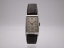 Front view of the vintage PRONTO watch with cream dial and brown leather strap on a stand.