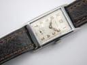 Angled close-up of the PRONTO watch dial, showcasing the cream face, legible Arabic numerals, and small seconds sub-dial.