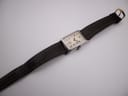 Top-down view of the PRONTO watch laid flat, displaying the brown leather strap and overall length.