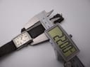 Digital caliper measuring the lug-to-lug length of the PRONTO watch at 38.04mm, with the watch on a brown leather strap.