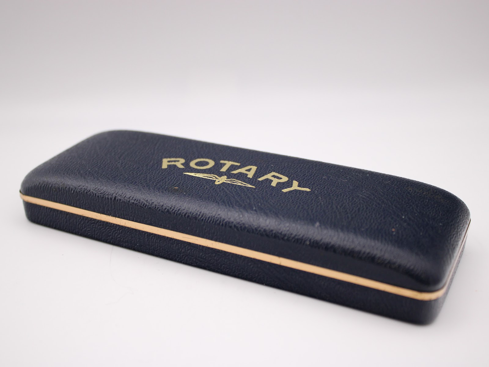 Closed original blue Rotary watch box with gold lettering on the lid, presented against a white background.