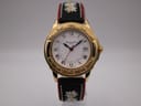 Front view of the Michel Jordi 1991 Cuvee CH watch, showcasing the white dial, gold tone case, and embroidered black leather strap.