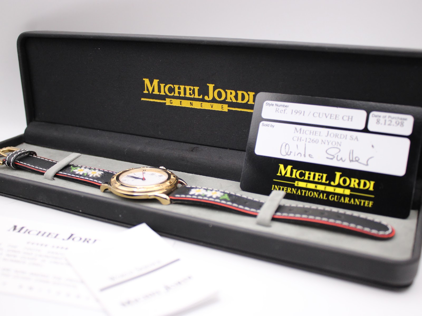 Michel Jordi 1991 Cuvee CH watch in its original black presentation box, alongside the international guarantee card.