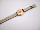 Full back view of the watch on a display stand, showing the case back details and the underside of the strap.