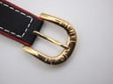 Close-up of the watch's gold tone buckle, clearly engraved with the 'MICHEL JORDI' brand name.