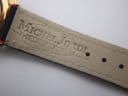 Interior view of the black leather strap, showing the embossed 'MICHEL JORDI GENEVE' text.