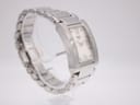 Angled side view of the Tissot t007309 a watch on a stand, showing the left side of the rectangular case and bracelet links.