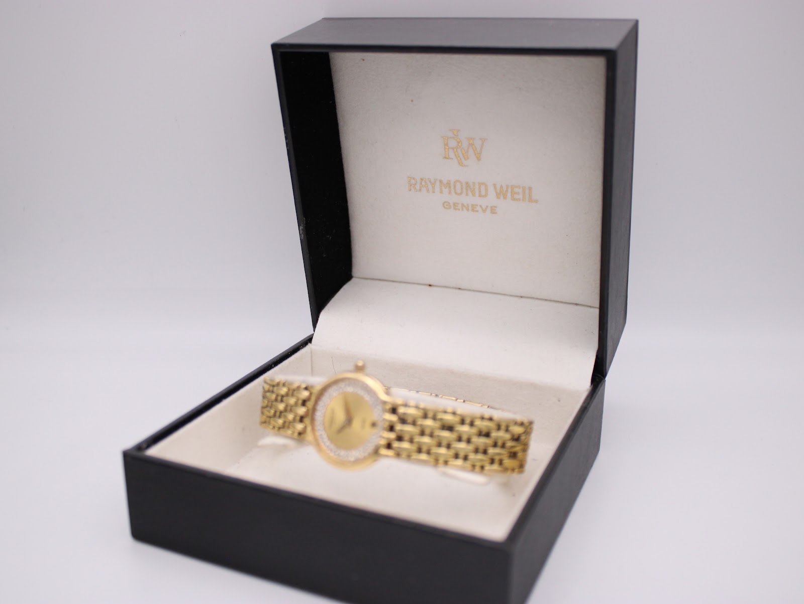 Raymond Weil Fidelio gold watch in its original black presentation box with gold logo.