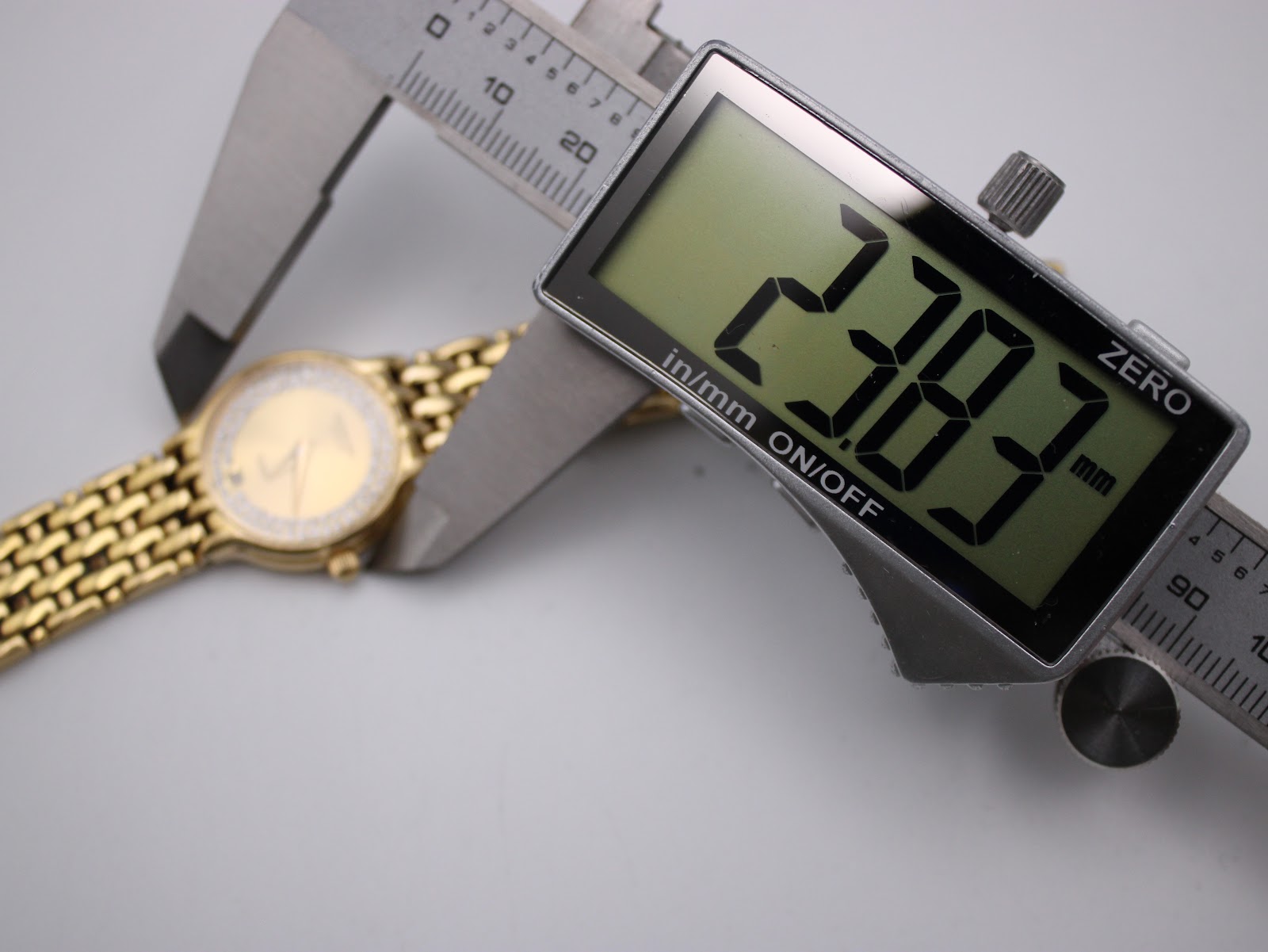 Digital caliper measuring the case diameter of the Raymond Weil Fidelio watch at 23.83mm.